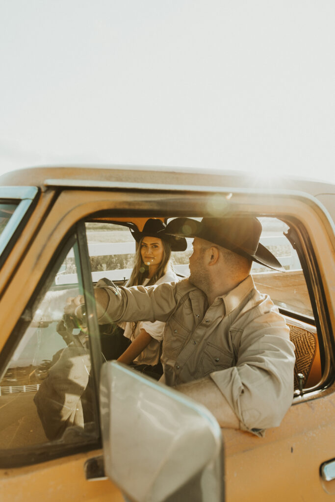 couple sitting inside of their old ford truck for their western engagement photography session